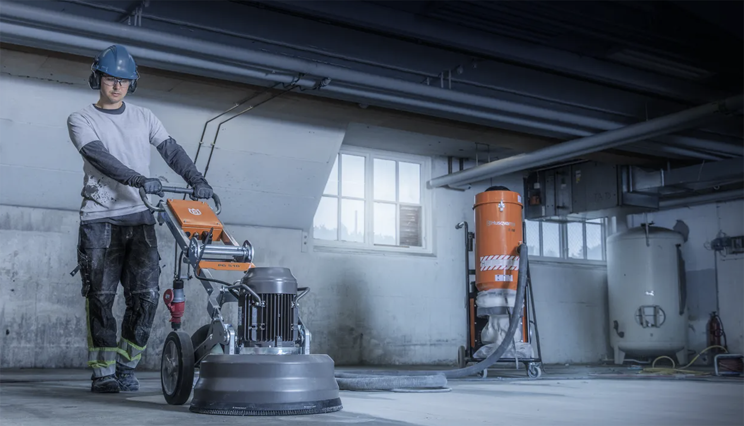 Construction Worker on a Job Site Using a Power Floor Grinder